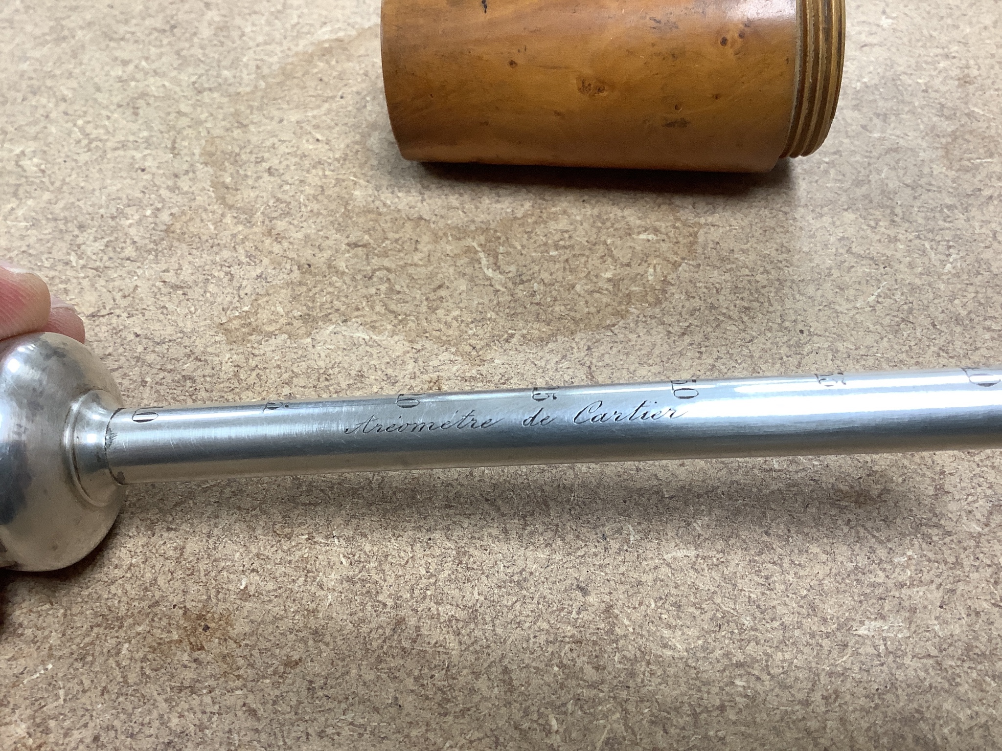 A French hydrometer inscribed 'Ariometer de Cartier' in treen case, overall height 19cm